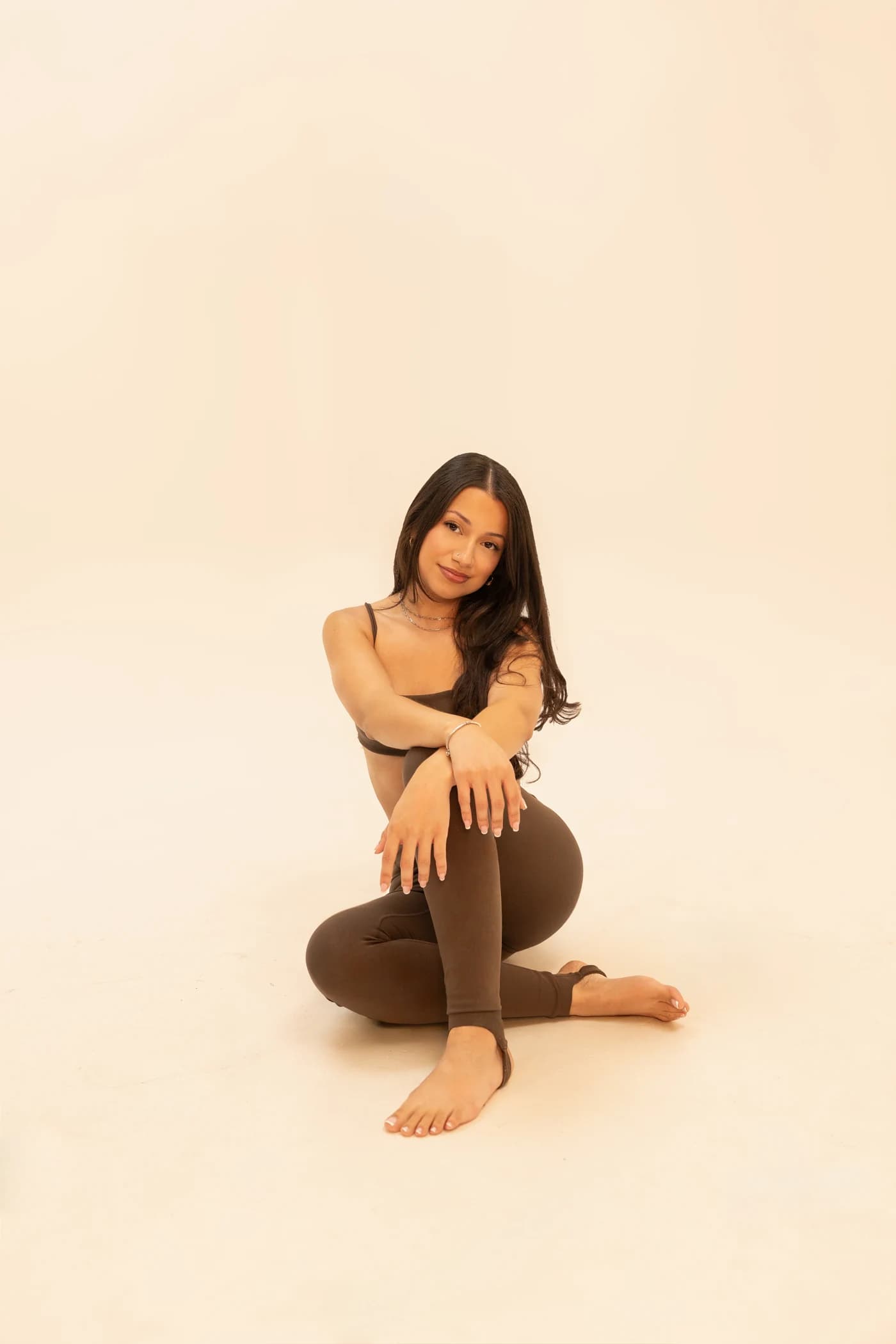 Denise seated on her mat